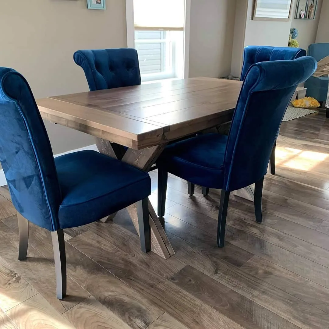 Custom dining table paired with blue upholstered chairs