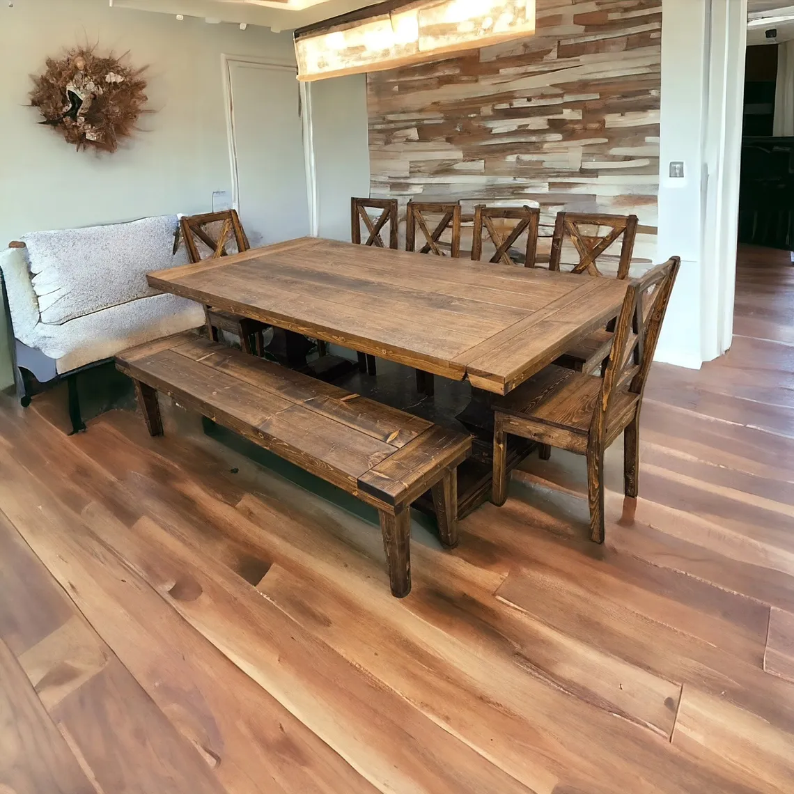 Walnut dining set with bench seating beside a brick feature wall