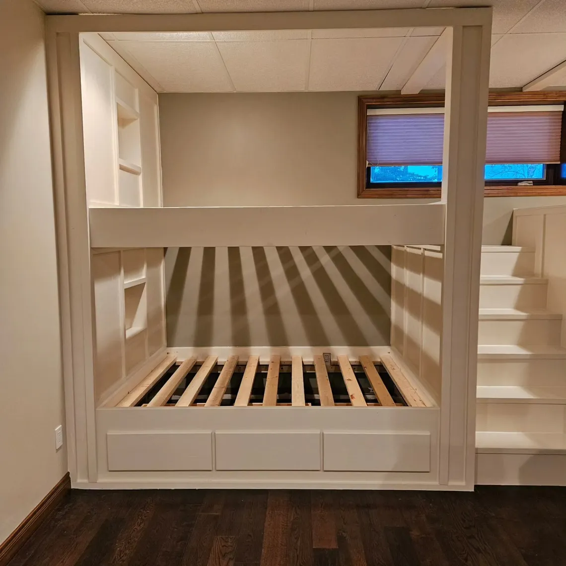 Painted bunk nook with storage drawers below