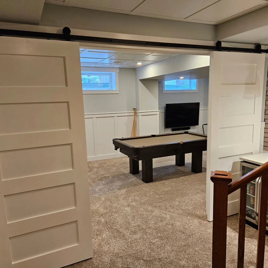 Custom built-in cabinetry with sliding barn doors